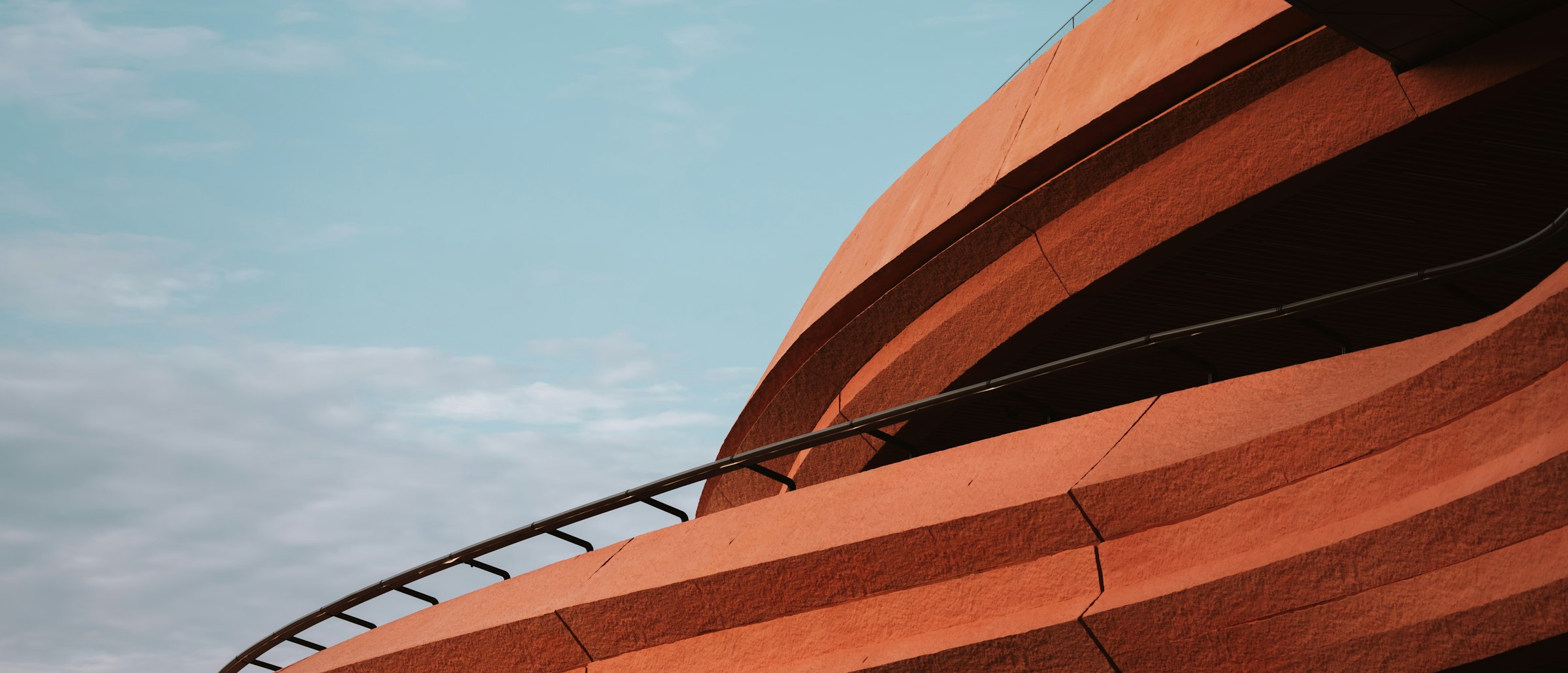 Valet Living — warm terracotta architectural curves (project design element)