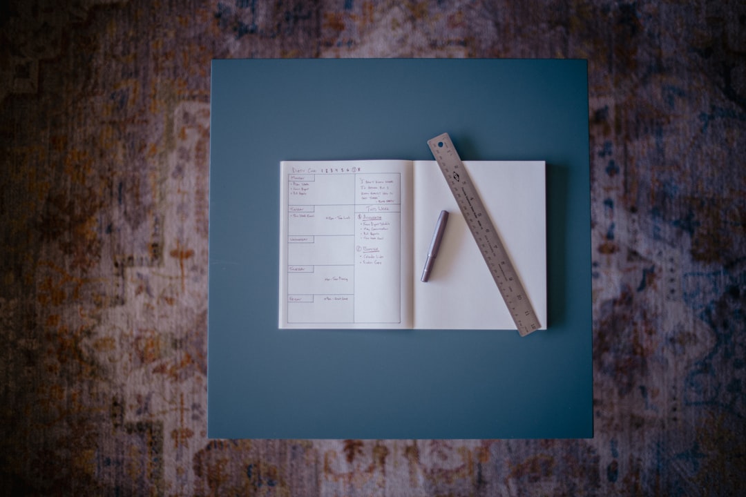 A book with a ruler resting on top of it