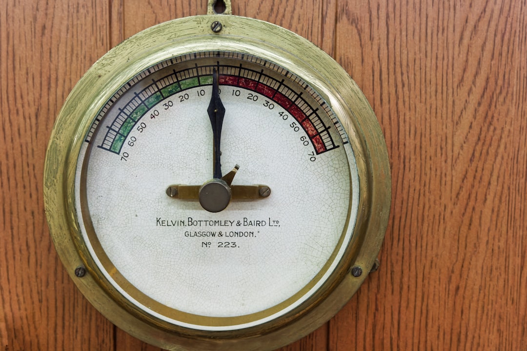 A thermometer on a wooden wall