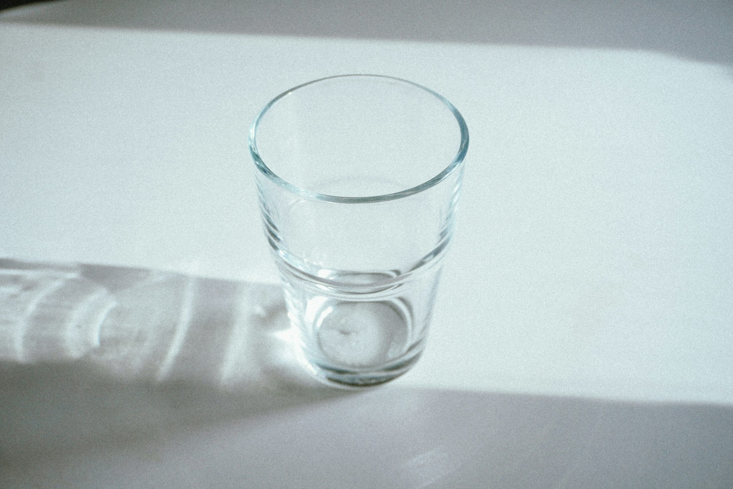 A glass of water sitting on top of a table