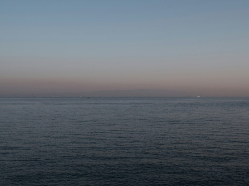 Calm ocean horizon at dusk with soft sky colors