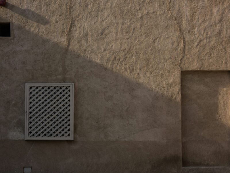 A wall with a window and a door on it