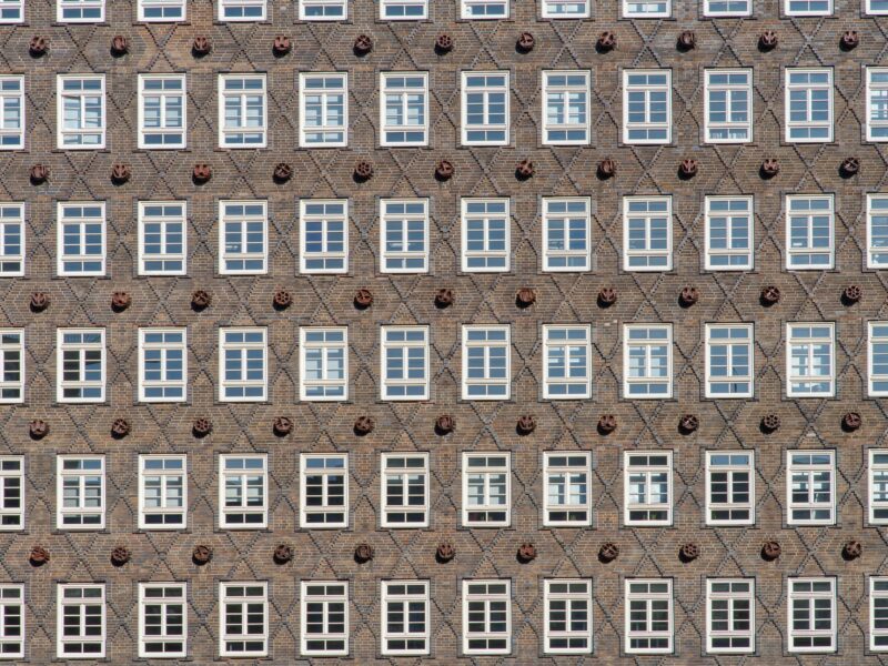 Rows of identical windows on a brick building facade.
