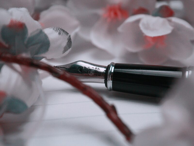 A pen sitting on top of a piece of paper