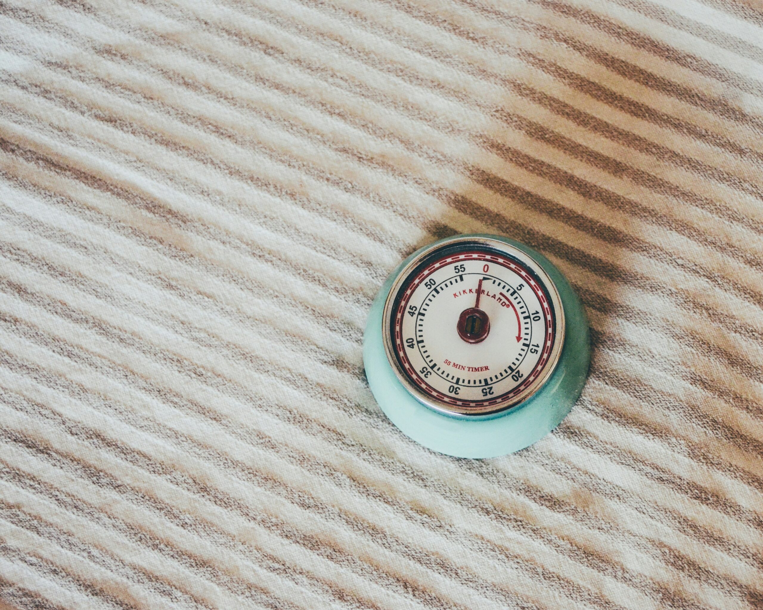 Round teal gauge on white textile