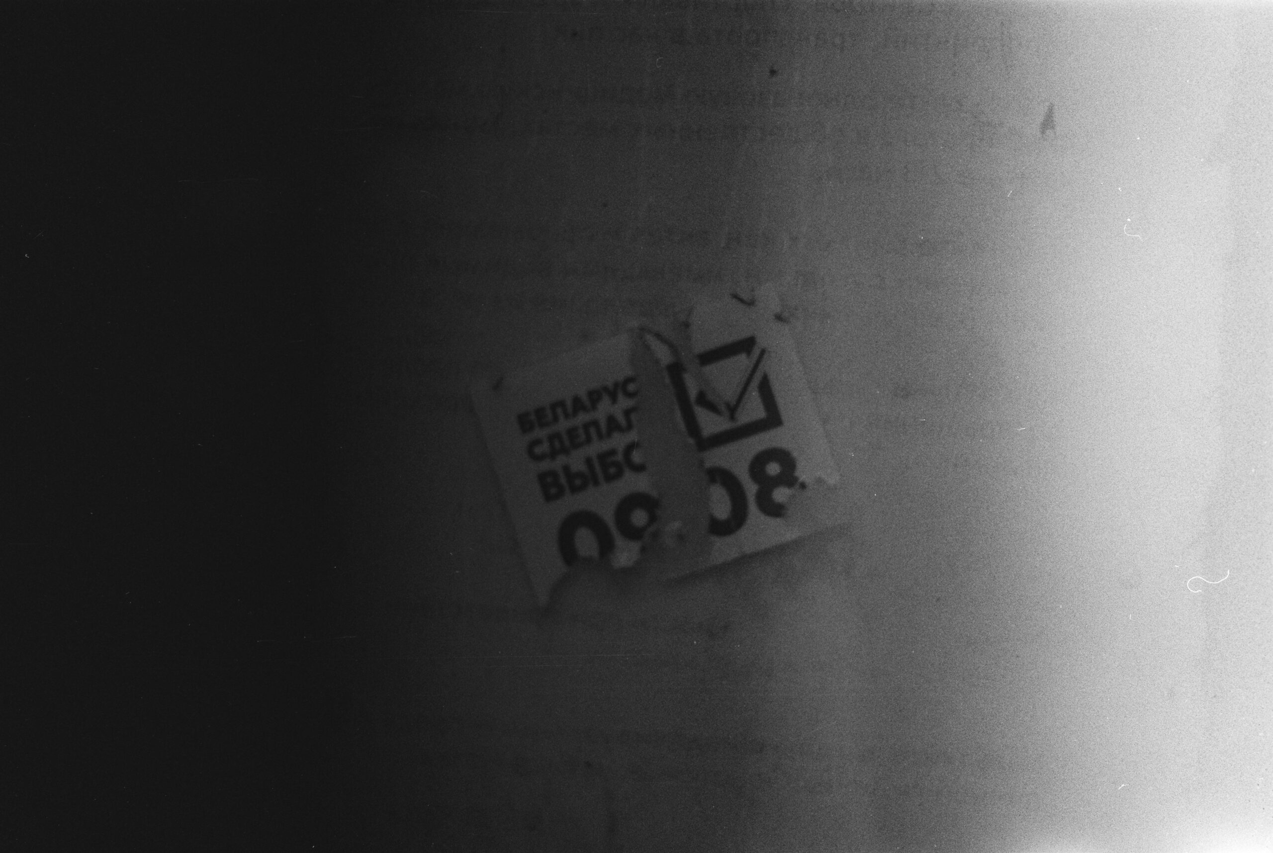 A black and white photo of a sign on a wall