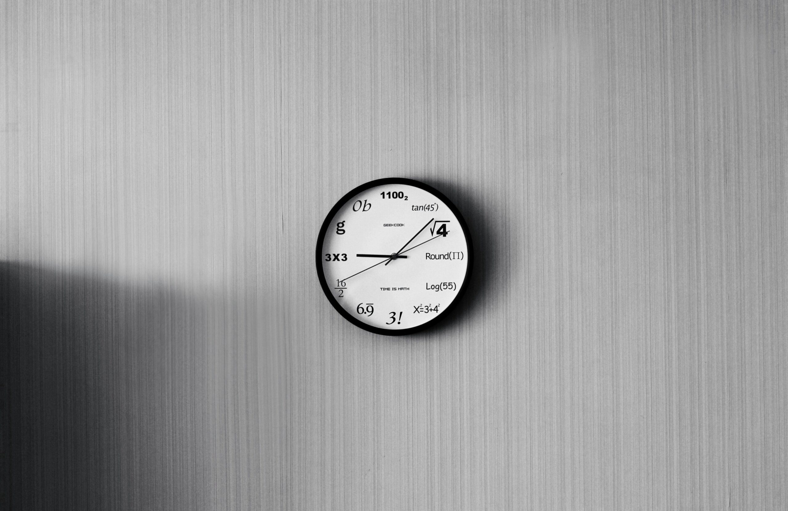 Round white and black analog watch reading at 9:10